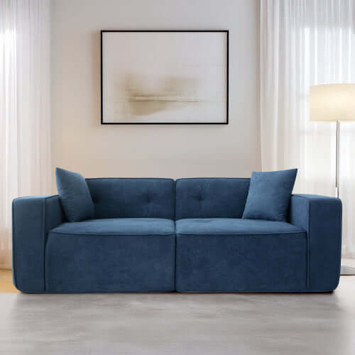 Modern low profile blue box arm memory foam sofa in stylish living room setting with natural light.