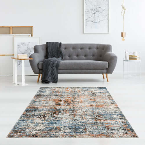 Abstract multi-color area rug enhances modern living room with vibrant colors and contemporary design.