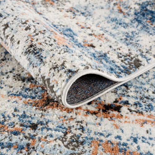 Close-up of an Abstract Multi-Color Area Rug showcasing vibrant blues and oranges, perfect for modern home decor.