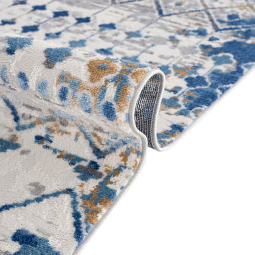 Close-up of Moroccan styled blue and beige woven area rug showing soft texture and intricate design.