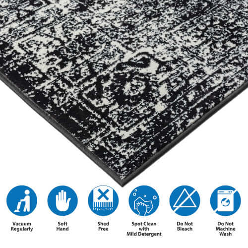 Detailed view of distressed vintage Persian styled woven area rug with care instructions and soft texture.