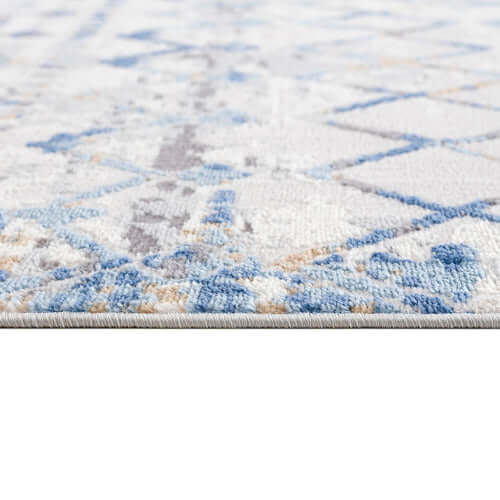 Close-up of Moroccan styled blue and beige area rug, showcasing intricate patterns and soft texture, ideal for cozy living rooms.