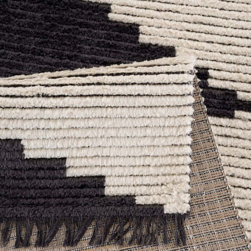 Close-up of Black & Ivory Modern Diamond Design Area Rug showing texture and pattern detail.