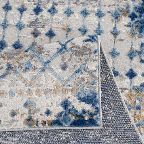Close-up of Moroccan styled blue and beige woven area rug showcasing intricate patterns and textures.