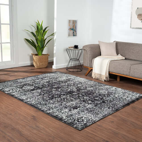 Distressed vintage Persian styled woven area rug in modern living room, 8x10ft size adding elegance to the space.