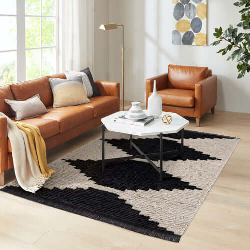 Black & Ivory modern diamond design area rug in stylish living room setting with leather furniture.
