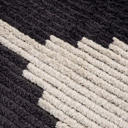 Close-up of a Black & Ivory Modern Diamond Design Area Rug showcasing textured patterns.