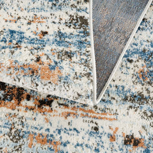 Close-up of Abstract Multi-Color Area Rug showcasing vibrant textures and colors, perfect for modern living spaces.