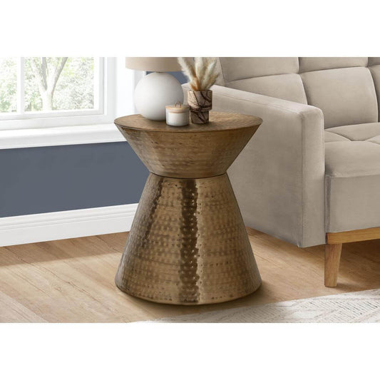 Hammered Metal Hourglass Drum Accent End Table – Modern Sculptural Side Table (3 Colors) with textured finish next to a sofa.