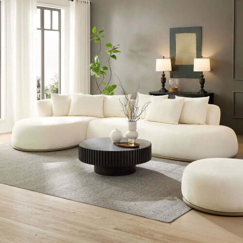 Cozy white L-Shaped Chaise Sofa Sectional with plush cushions, accented by a modern black coffee table.