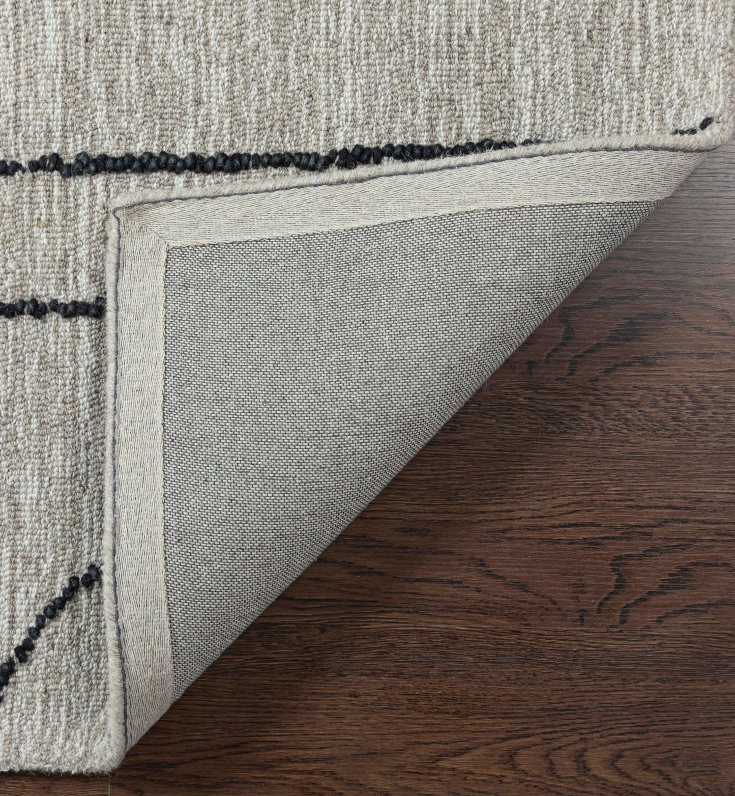Close-up of Abbey Valetta handwoven wool area rug corner showcasing durable backing and textured surface.