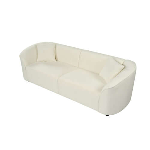 Contemporary sloped arm boucle upholstered sofa in white with sculptural curved design and plush cushioning.