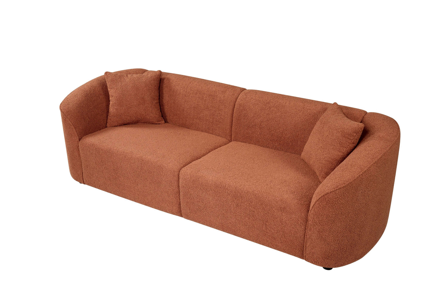 Contemporary sloped arm boucle upholstered sofa in warm orange color with cushions, showcasing modern design and ergonomic comfort.