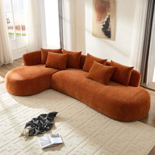 Rounded L-Shaped chaise sofa sectional in orange with plush pillows, ideal for cozy living spaces.