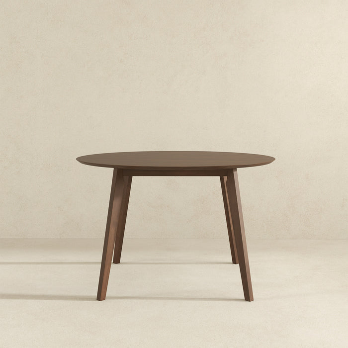 The Alina MCM Round Walnut Wood Dining Table 43 by Ashcroft Furniture showcases a minimalist mid-century design with four angled legs, and is available in two customizable finishes.