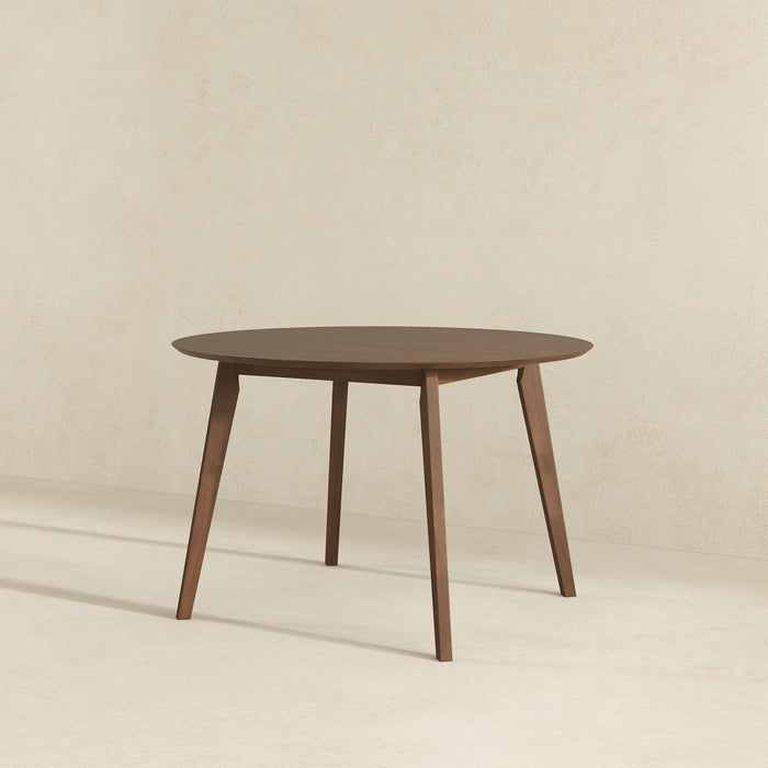 The Alina MCM Round Walnut Wood Dining Table 43 by Ashcroft Furniture features a smooth surface and four angled legs, shown here against a plain, light-colored background.