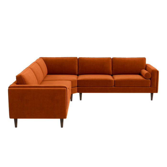 The Amber MCM Corner Sectional Sofa by Ashcroft Furniture, shown in burnt orange, features modern L-shaped design, premium craftsmanship, clean lines, three seat cushions per side, short wooden legs, and a matching cylindrical pillow.