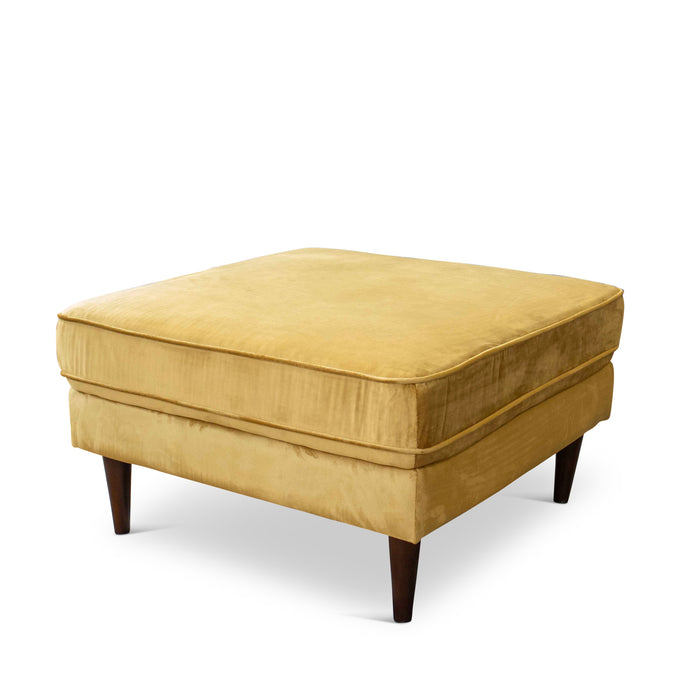 The Amber MCM Square Upholstered Ottoman 32 by Ashcroft Furniture features a square, mustard yellow cushioned top and dark wooden legs in Mid-Century Modern style, shown against a white background.