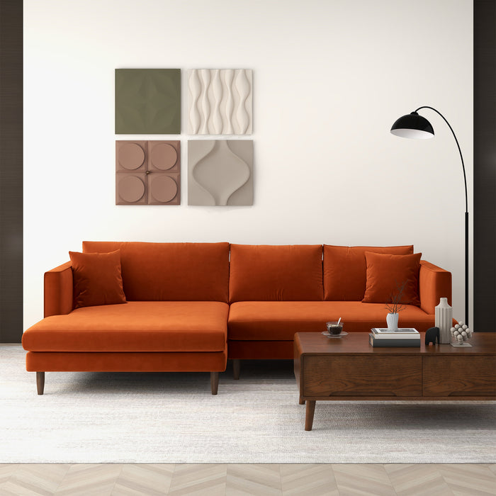 A modern living room with the Ashcroft Furniture Blake Velvet Upholstered L-Shape Chaise Sofa Sectional 107, a wooden coffee table, black floor lamp, and four geometric wall art pieces above the sofa for a touch of modern elegance.