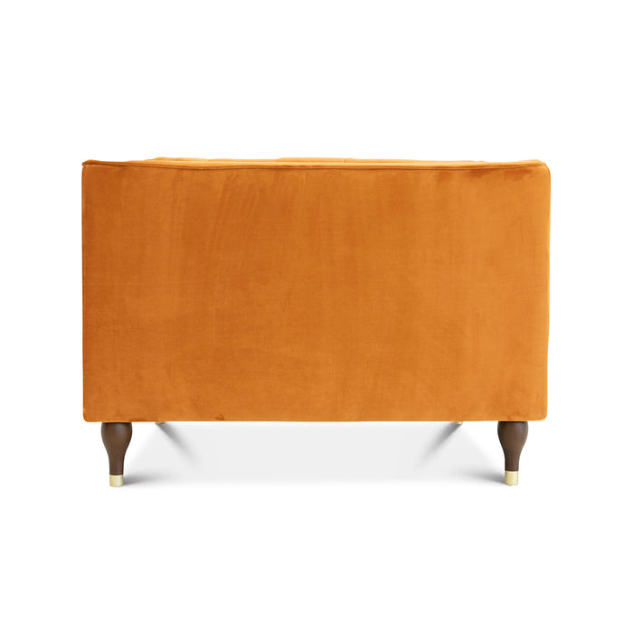 The Evelyn Mid-Century Tufted Velvet Lounge Chair 42 by Ashcroft Furniture features plush mustard yellow velvet, wooden legs with gold-toned tips, and a subtle mid-century design, shown from the back against a plain white background.