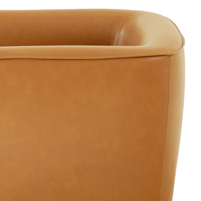 Close-up of Callan Faux Tan Leather Swivel Chair showcasing its stylish barrel shape and luxurious upholstery.