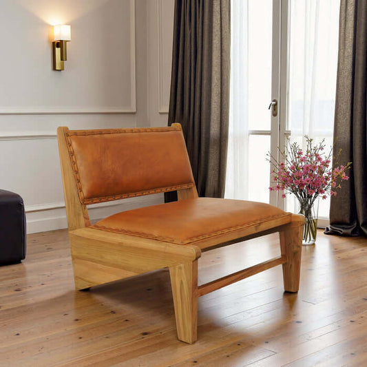 Talon Solid Wood Tan Leather Armless Lounge Chair in modern interior setting with flowers.
