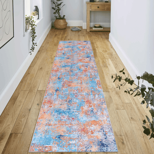 Multi-Colored Abstract Washable Area Accent Rug laid on wooden floor in a modern interior setting.
