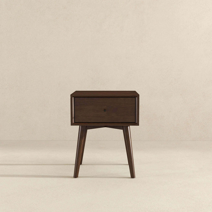 The Avery Solid Wood Nightstand with Drawer by Ashcroft Furniture Co. features a walnut finish, single drawer, and four angled legs in mid-century modern style, set against a plain light background.