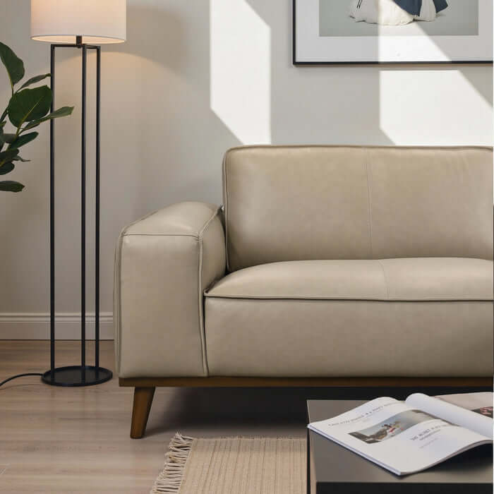 Kerrville beige leather sofa sectional in modern living room, featuring sleek design and cozy comfort.