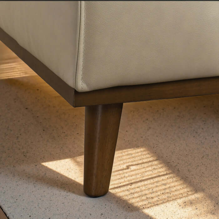 Close-up of Kerrville Beige Leather Sofa Sectional leg, showcasing its modern design and quality craftsmanship.