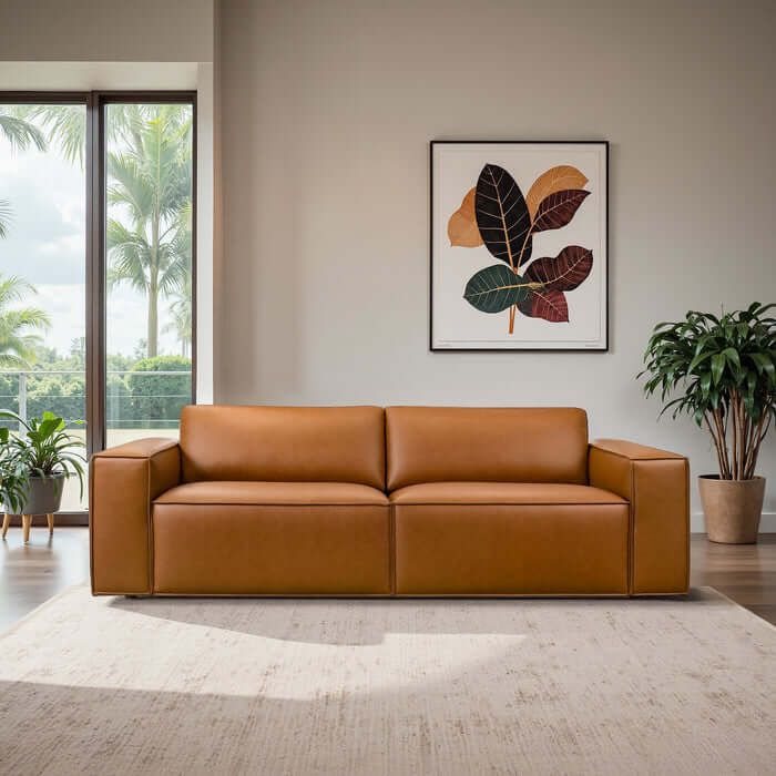 Uvalde MCM Vegan Leather Wide-Arm Sofa in cognac, showcasing mid-century modern design in a bright living space.