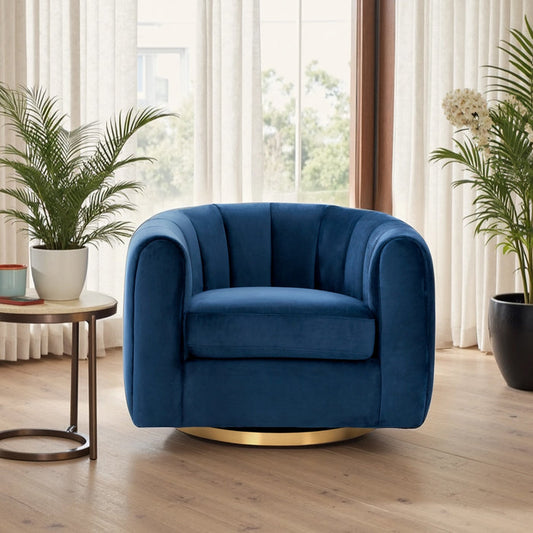 A modern living room features the Cosey Green Channel Tufted Velvet Swivel Chair by Ashcroft Furniture Co., its plush velvet and gold base set on light wood floors beside a round side table with potted plants. Sheer curtains filter natural light from large windows.