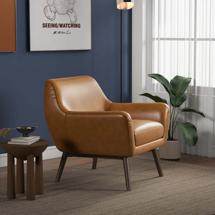 Panom MCM Tan Genuine Leather Lounge Chair in modern living room setting with plant and art.