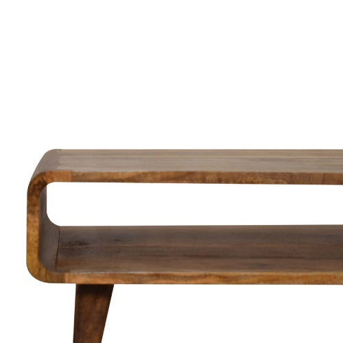 The Artisan Furniture MCM Solid Mango Wood Coffee Table 26 features a warm chestnut finish, Mid-Century charm, rounded edges, and an open rectangular shelf below, displayed against a white background.