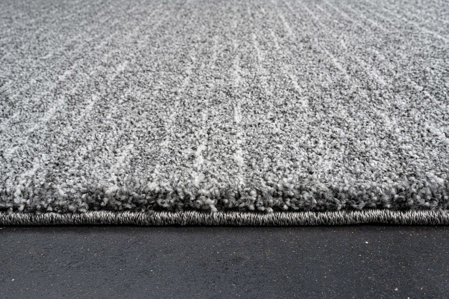 Lydia Rectangular Gray & White Striped Polypropylene Area Rug (3 Sizes) with plush texture and modern design.