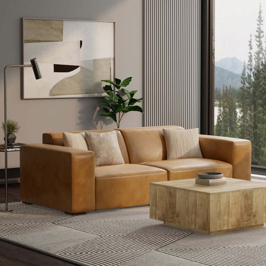 Rex Modern Top-Grain Leather Modular Sofa in Sienna with pillows and wooden coffee table in a stylish living room.