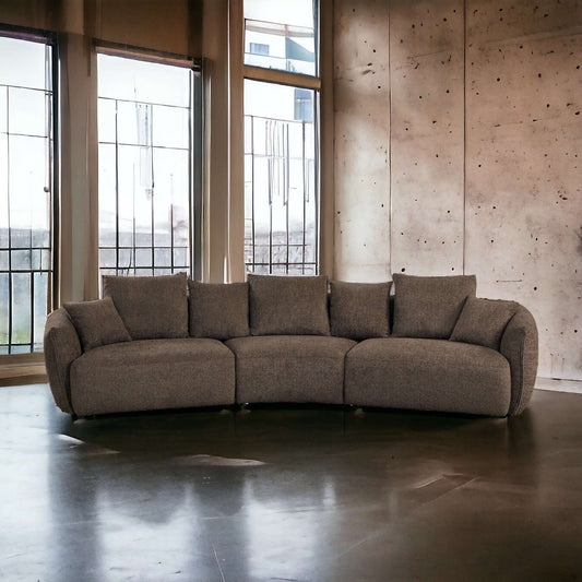 Bash Macca Anthology Brown Boucle Modular Sectional Sofa 145" in a chic, modern living space with large windows.