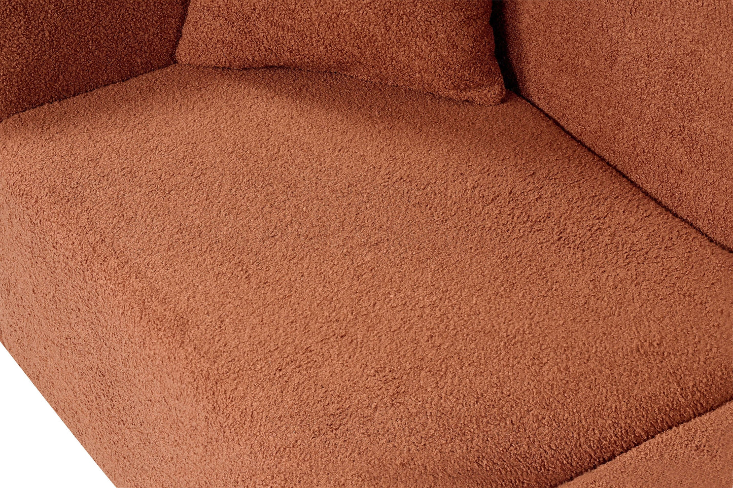 Close-up of soft bouclé upholstery on a contemporary sofa cushion in warm brown shade.