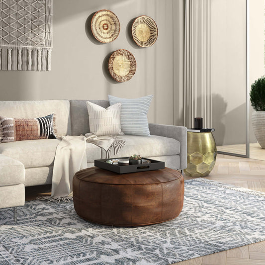 Connor Brown Buffalo Leather Ottoman 34" – Round Top-Grain Leather Pouf in a stylish living room setting