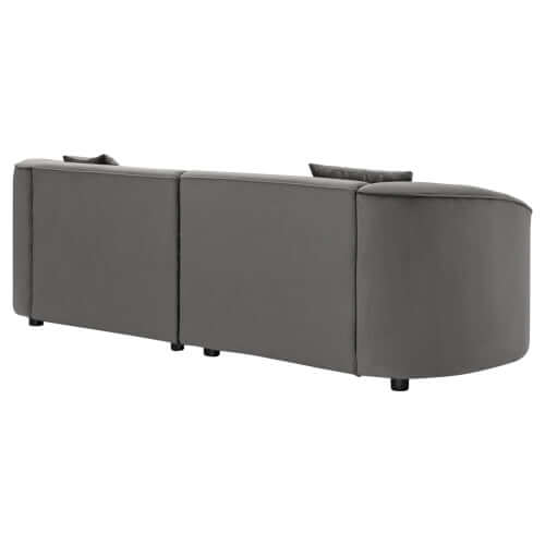 Contemporary sloped arm boucle upholstered sofa in sleek gray, showcasing bold curves and modern design.