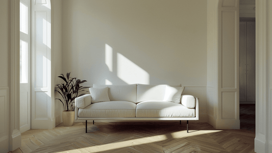 Modern white sofa in a bright room demonstrating sofa fitting measurements for purchase considerations.