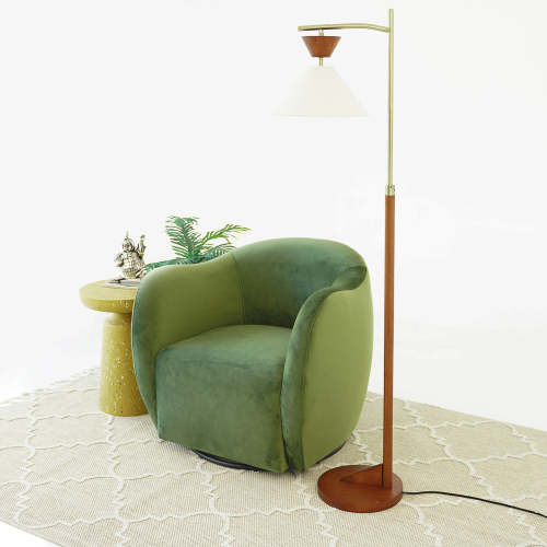 Swivel Lounge Chair in Green Velvet – Renee Modern Barrel Accent Chair beside a stylish lamp and decorative table.