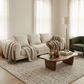 100" Cream Fabric Sofa with Brown Wood Legs & Rounded Arms in a cozy living room setting.