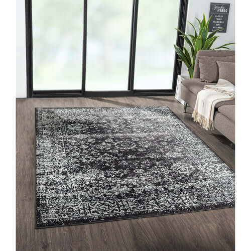 Distressed vintage Persian styled woven area rug in a modern living room setting, 8x10ft, showcasing timeless elegance.