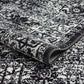 Distressed vintage Persian styled woven area rug with intricate patterns in black and white, ideal for modern decor.