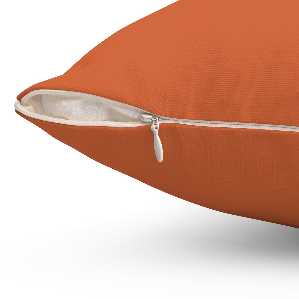 Close-up of Orange Polyester Pillow Revel Logo zipper detail for stylish home decor.