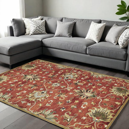 Rust Beige And Gray Wool Floral Medallion Hand Tufted Area Rug | 9' x 13' under a gray sectional sofa.