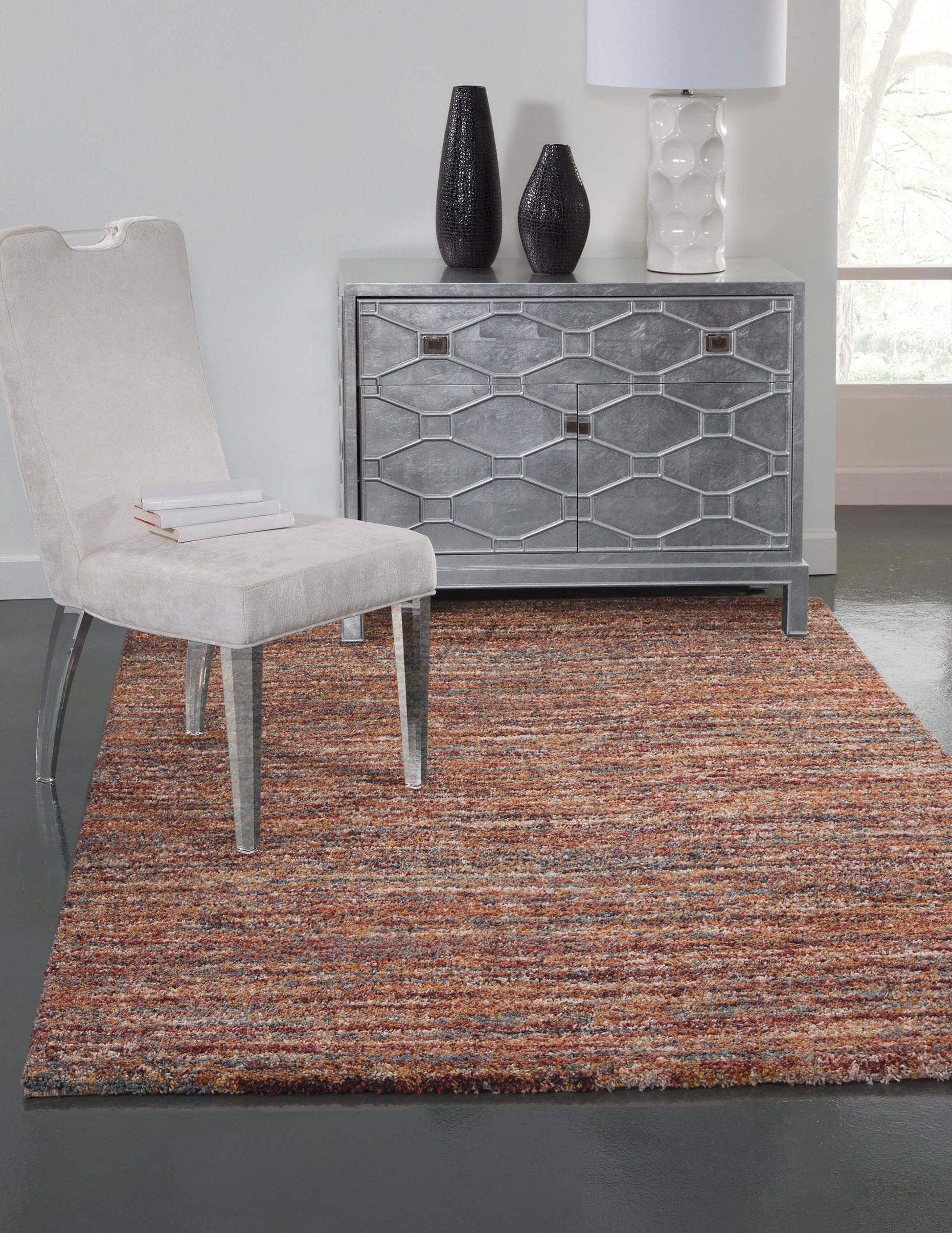 Zira multicolor rectangular area rug in modern living space with chair and decorative furniture.