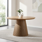47-Inch Modern Round Dining Table for 4 with natural wood finish and slatted base in bright dining space.