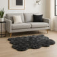 Scalloped faux fur shag rug in stylish living room with gray couch and decorative pillows.